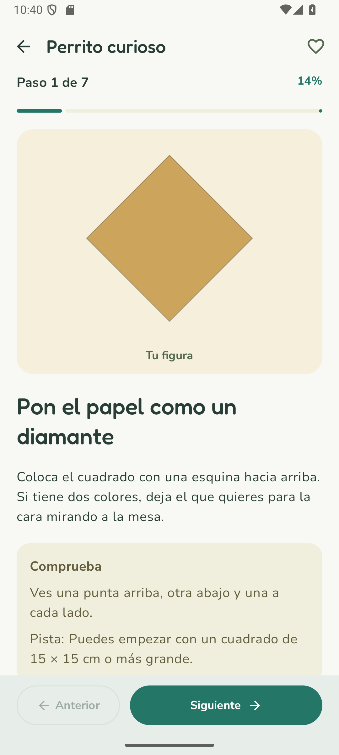Primer paso del perrito: colocar el papel como un diamante, con dibujo e instrucciones en español
